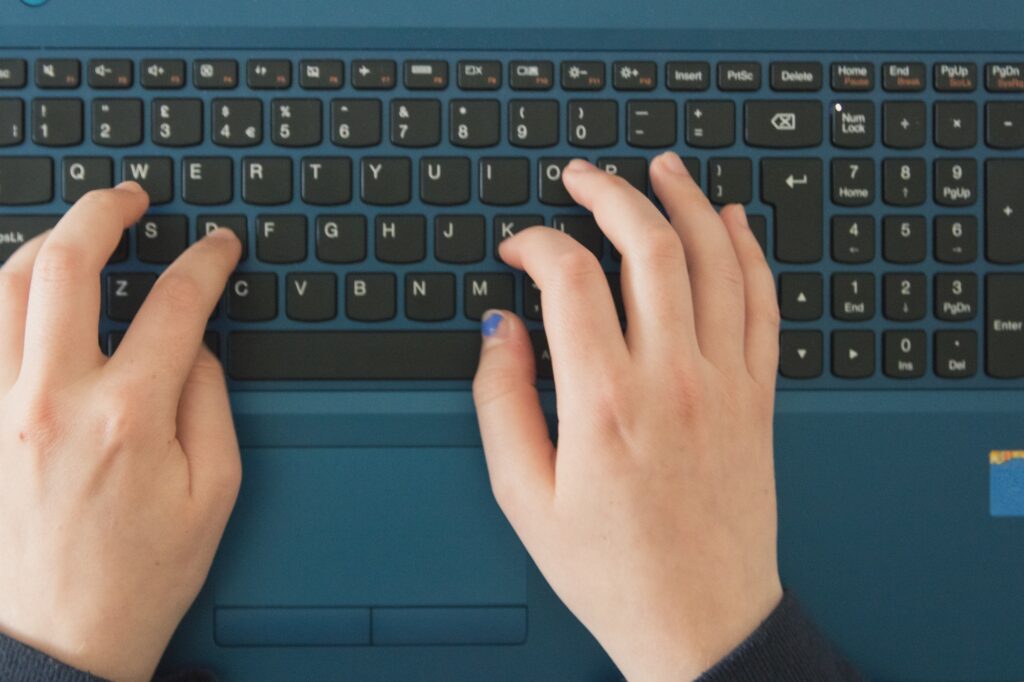 Woman typing on a keyboard.